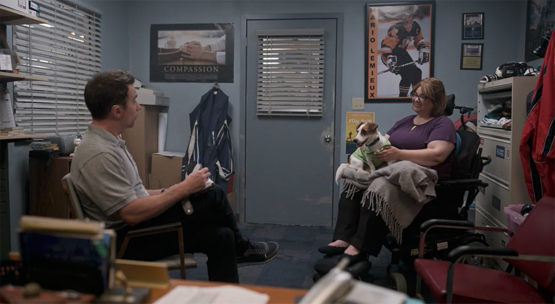 Ophira on set in a scene with a dog.