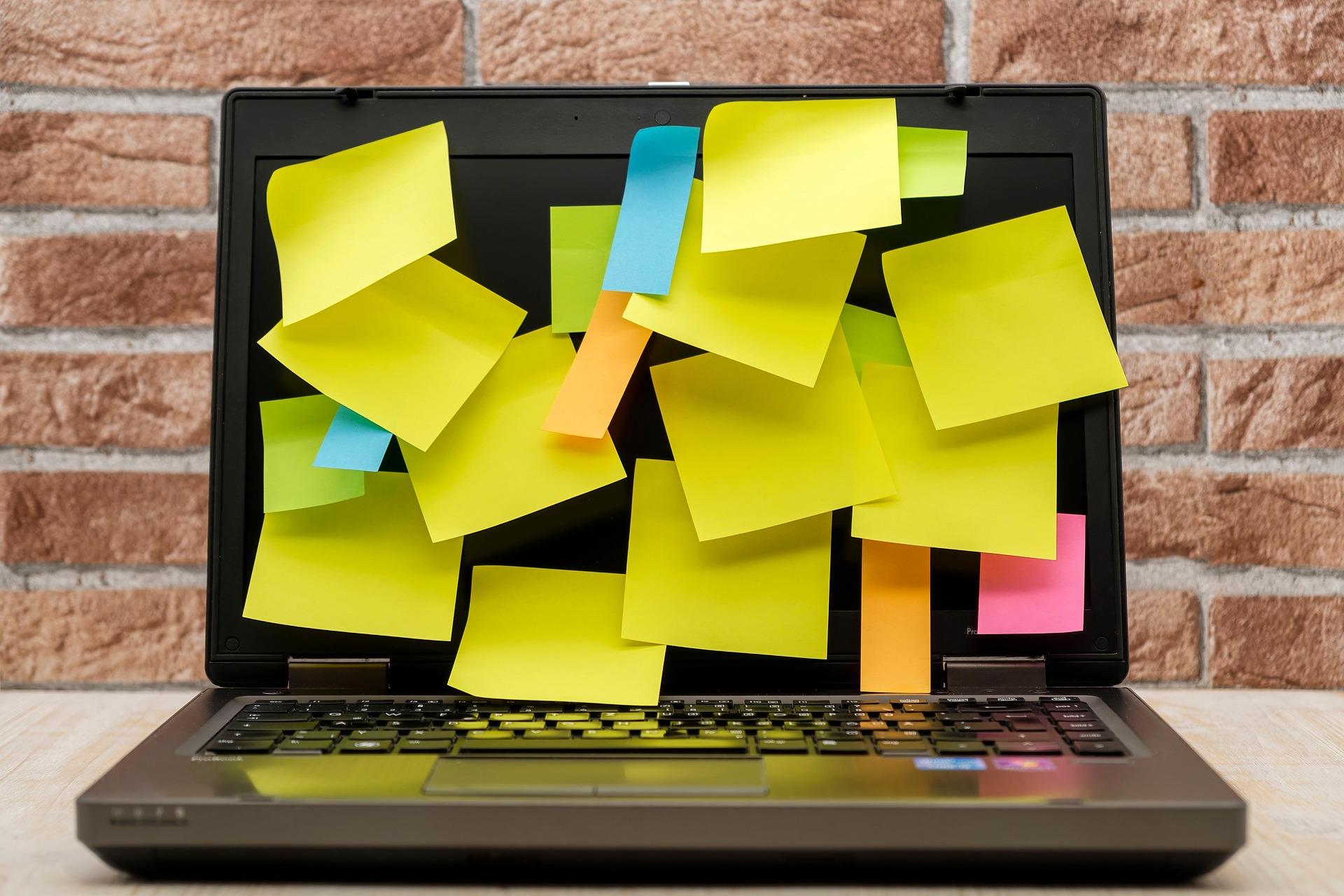 Laptop covered in sticky notes