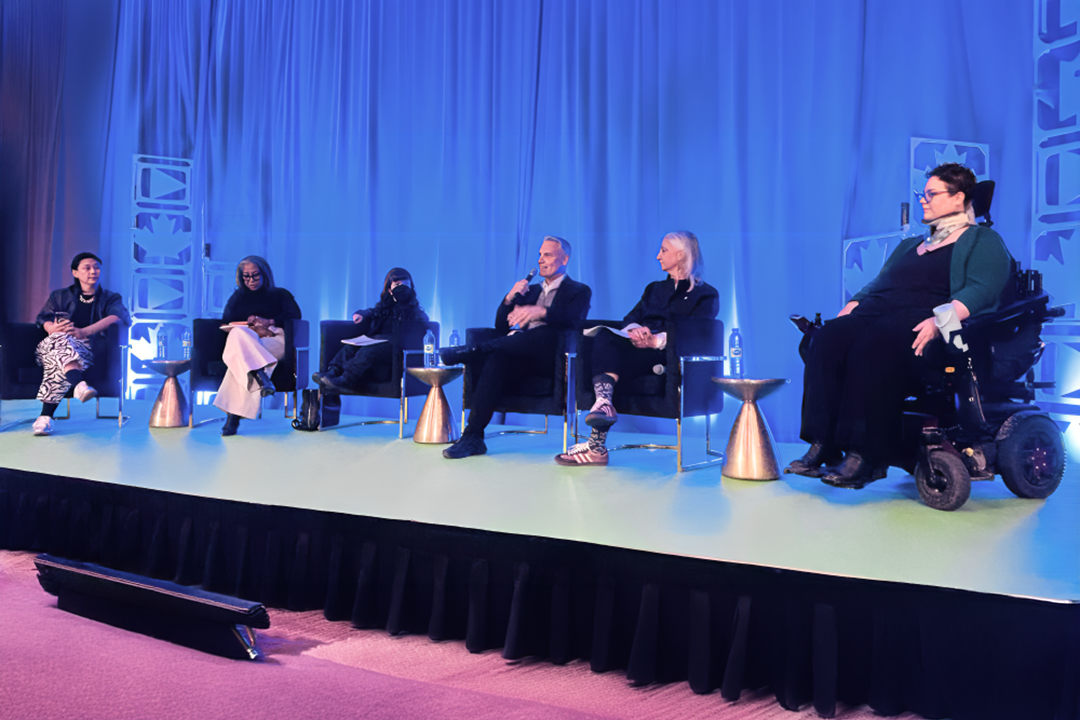 Ophira on stage with a panel.